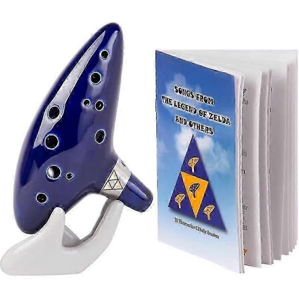 [14]ASQ Zelda Ocarina 12-reikäinen Alto C laulukirjalla (kappaleita The Legend of Zeldasta) näyttötelineellä ja suojakotelolla
