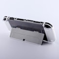 Pikkukuva 5 / 6: Yhteensopiva Nintendo Switch OLED Protector -läpinäkyvän suojakotelon kanssa jalustalla Transparent