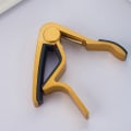Miniatyrbild 1 av 3: Guldfärgad gitarr capo - Gitarr metall stämningsklämma CAPO folk el wo