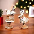Set med 2 tomte- och tomtemor-figurer i harts, juldekorationer