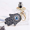 Miniatyrbillede 2 af 4: Hamsa Hånd af Fatima Nøglering Ondt Øje Nøglering med Krystal Rhinestones Harpiks Lykkelig Nazar Amulett Djævelens Øje Palm Charm Nøgleholder til Kvinder Mænd Bil