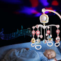 Pikkukuva 8 / 8: Lasten sänkyyn ripustettava mobiili valoilla ja musiikilla, projektori ja kaukosäädin