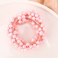 Miniatyrbild 2 av 4: Elegant Hårsnodd med Rosa Pärlor - Förvandla Din Hästsvans Rosa