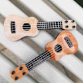 Miniatyrbild 2 av 4: Barnens Mini Fyrasträngade Gitarr Instrument (Beige) 1 Styck Beige