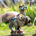 Miniatyrbillede 5 af 5: Udendørs havegnomstatue - Spisende dinosaur, humoristisk havegnom