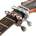 Miniatyrbilde 3 av 5: Sett med 2 gitar capoer med dødningehode-knottdesign, universelle strenger, instrumenter