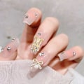 Miniatyrbild 4 av 5: 30 st pärlbågsnagelsmycken, 3D guld kors bågspänne nagelstrass, boxade söta nagelkonstbågar nagel D