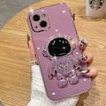 Pikkukuva 1 / 6: 6D galvanoitu astronautti piilotettu jalustakotelo iPhonelle Naisten astronautti taittuva jalusta iPhone-kotelo kamerasuojalla Pehmeä TPU iskunkestävä puskuri Purple iPhone XS max
