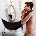 Miniatyrbillede 4 af 7: Forklæde til barbering og skæg / Skægforklæde - Opsamler skægget Sort