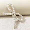Miniatyrbilde 1 av 4: Hair clip with beads in the shape of a bow White one size