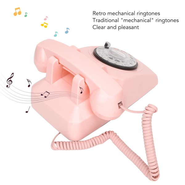 Vintage vaaleanpunainen langallinen pyörivä puhelin, jossa mekaaninen soitto- ja kaiutintoiminto