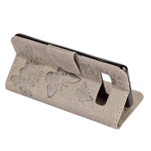 Samsung Galaxy S10 sommerfugle- og blomstertryk læder flip etui - Grå Silver grey