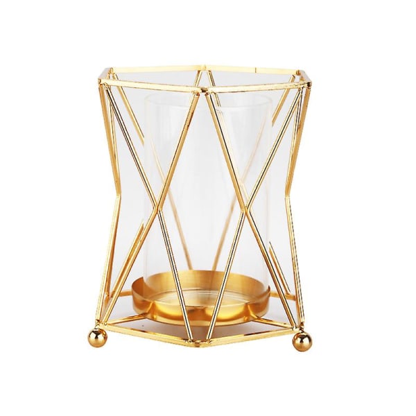 Lasimaljakko geometrisella metallitelineellä, kultainen kynttilänjalka pilarikynttilöitä varten