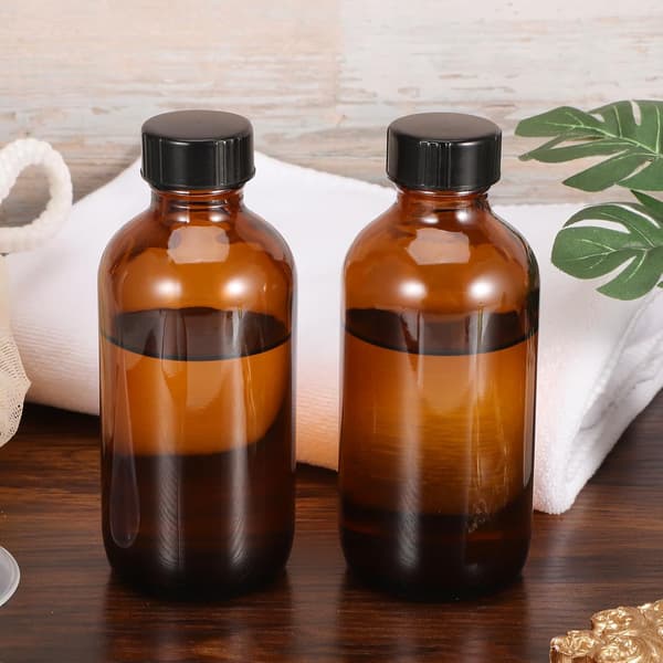 Bärnstensfärgade runda glasflaskor 120 ml med bakelitlock 4 st för eteriska oljor och resedispensrar