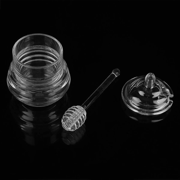 Hunajapurkki lusikalla ja kannella lasin lämmönkestävä lasipurkki säilytysastia