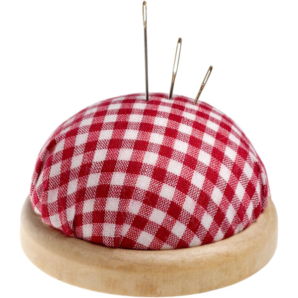 Pyöreä neulatyyny vaalealla puureunuksella, väri: punainen ja valkoinen (ruutukuvio).