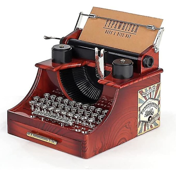 Pieni retrotyylinen kirjoituskone, kellotaulumusiikkilaatikko