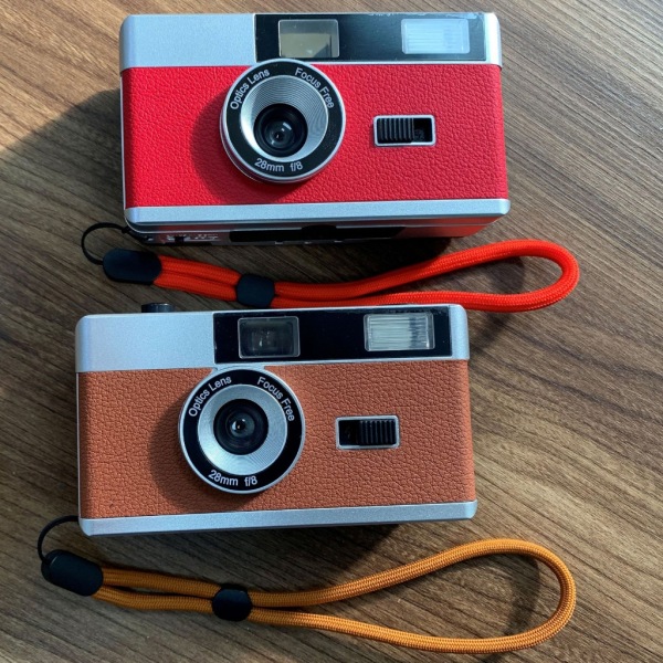 Retro 35 mm peka och skjut filmkamera med blixtfångstminnen i film perfekt för fotografintusiaster Red