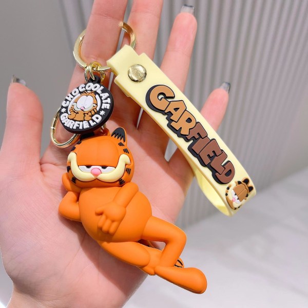 Sarjakuva-anime Garfield avaimenperä, ihana reppuriipus, luova kokoonpano Hold your chest