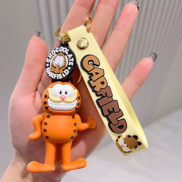 Sarjakuva-anime Garfield avaimenperä, ihana reppuriipus, luova kokoonpano Hold your chest
