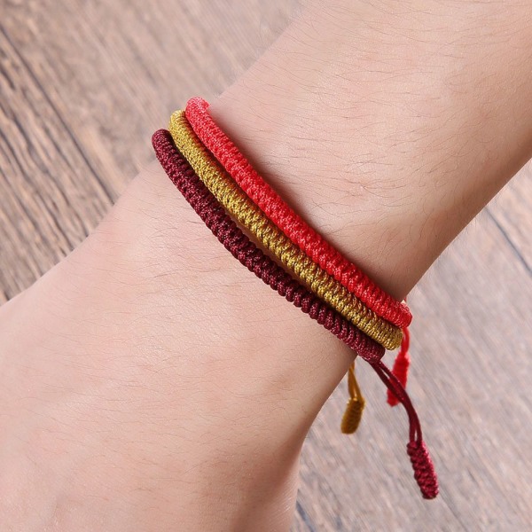 Lucky Rope Armband Tibetansk Buddhist Knots Stickat Håndlavet GULD