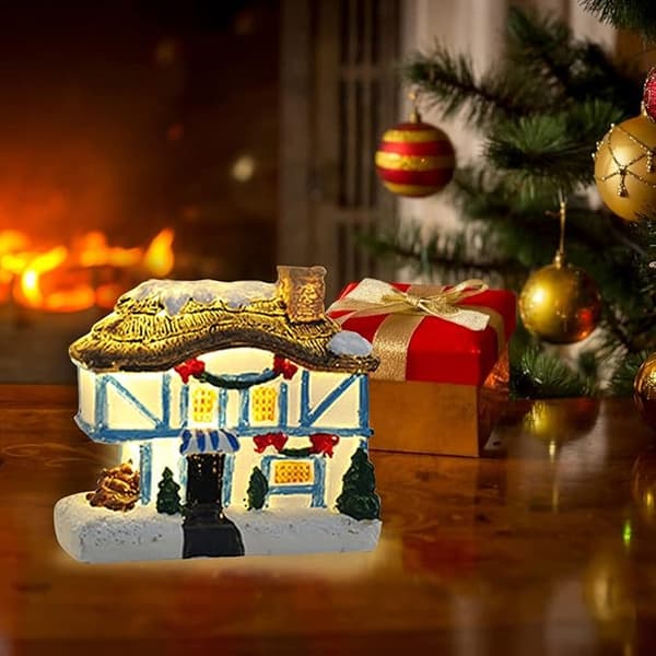 Julelandsbyhus med lys, lysende opp juleharpiks
