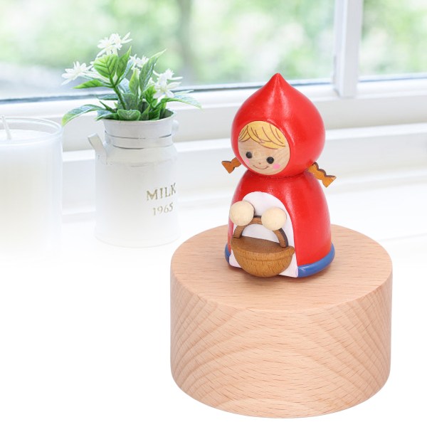 Minimusikdosa Handsnidad roterande musikalisk figurin i trä med rund bas Liten rödluva