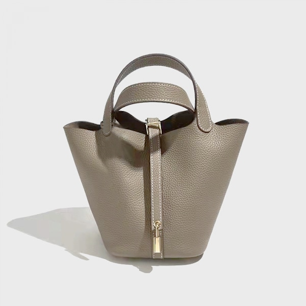 Litsinjyväinen pehmeä nahkainen kädessä pidettävä vihanneskassikori yksivärinen yksinkertainen olkalaukku crossbody-ämpärilaukku