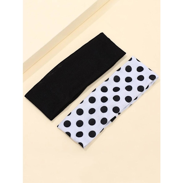 2 Stretch Hårband i polyester C:a 6 x 20 cm. 1 Svart 1 polka dot
