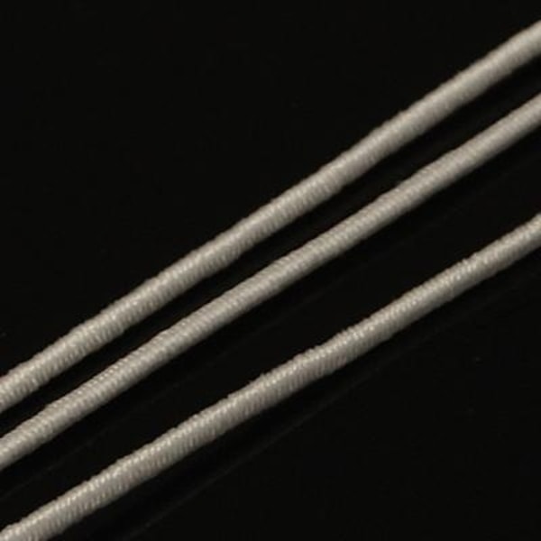 C;a  25 mt.Vit tygklädd elastisk tråd 1 mm. Ø i diameter