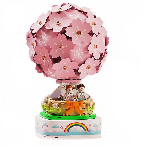 Monterade byggstenar med lampor i japansk stil körsbärsblommande speldosa varmluftsballong roterande små partiklar flicka present