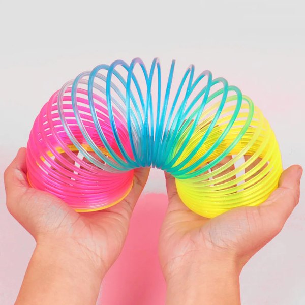 Regnbågsformad spiralfjäderleksak, klassisk nyhet och färgglad neonplastleksak, festtillbehör för pojkar och flickor