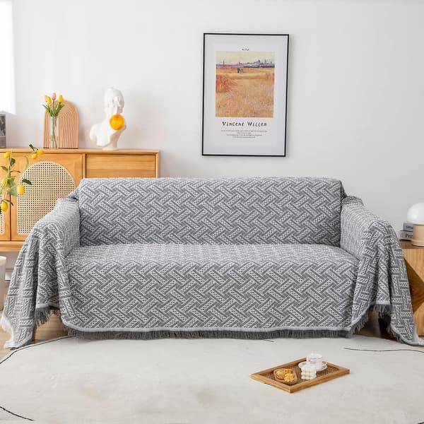 Multifunksjonelt sengeteppe eller sofateppe, grått og hvitt sammenvevd sofateppe med dusker 180 x 230 cm grå + hvit
