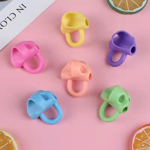 Ergonominen kirjoitustuki oikean kynän asennon saavuttamiseksi - 12 kynäpidikettä lyijykyniin ja värikyniin - oikea- ja vasenkätisille