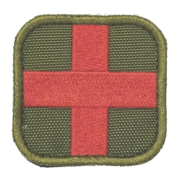 50 x 50 mm tarrakiinnitteinen ensiapulappu, punainen risti, ruskea (C)