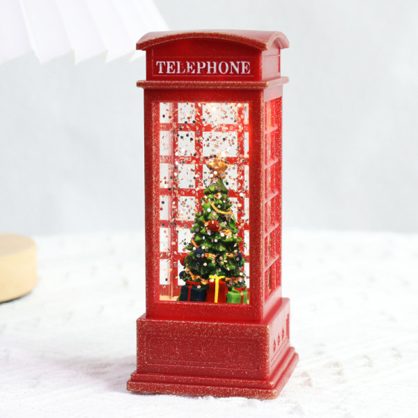 Ensimmäinen hehkuva joulukuusi puhelinkopissa, punainen puhelinkoppi. joulu tuulilyhty kristallilamppu