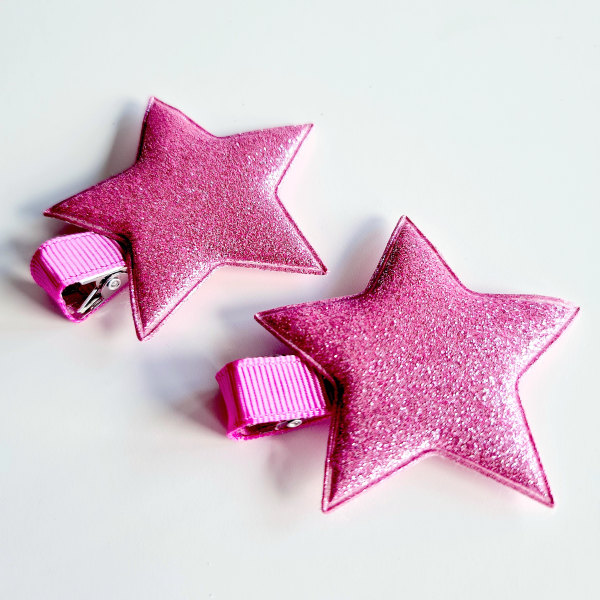 2 hårspännen med stor glittrig stjärna rosa