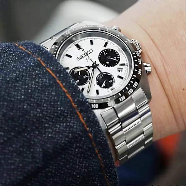 The 2025 Seiko watch features a stainless steel strap, a white dial, and a black dial, making it suitable for everyday use.