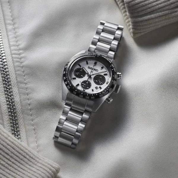 The 2025 Seiko watch features a stainless steel strap, a white dial, and a black dial, making it suitable for everyday use.