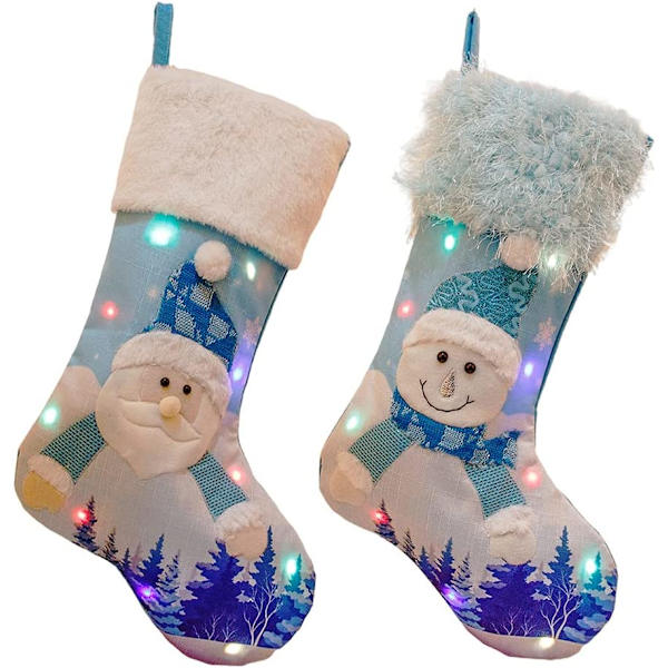 Ljusblå broderade julstrumpor att hänga