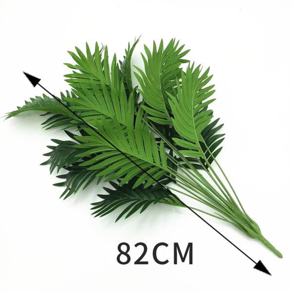 Keinotekoinen kasvi hajallaan pyrstö trooppinen keinotekoinen palmu puu isot kasvit lehdet väärennös palmu lehti