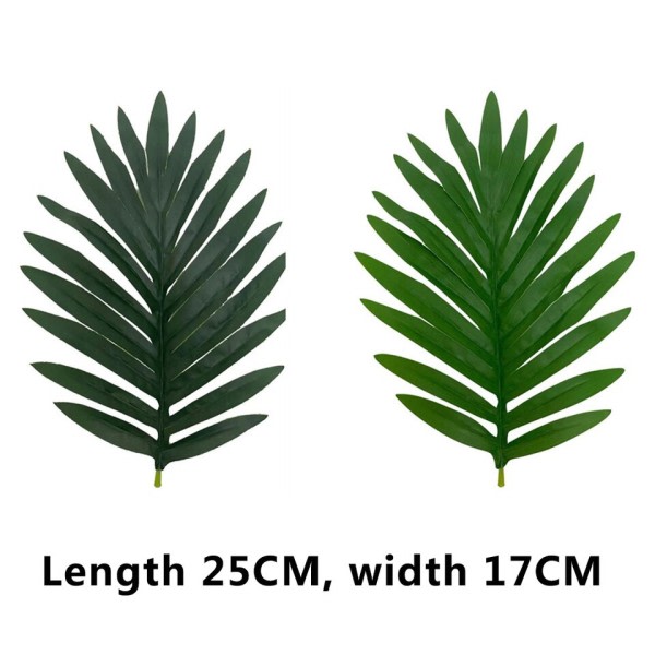 Keinotekoinen kasvi hajallaan pyrstö trooppinen keinotekoinen palmu puu isot kasvit lehdet väärennös palmu lehti