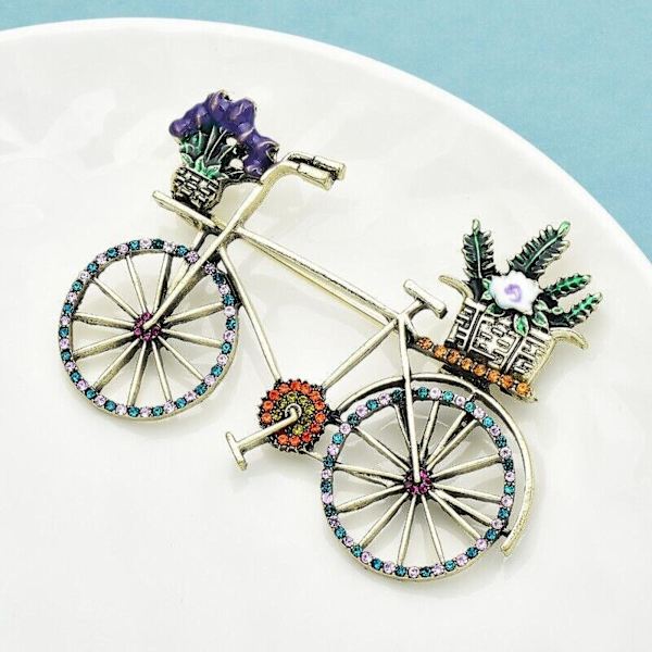Elegantti vintage-pyörän rintaneula, jossa on säihkyviä strassikiviä, jotka tuovat glamouria jokapäiväiseen asuusi, Metalli blue