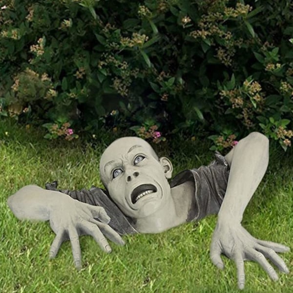 Halloween-bileet Zombie ryömii ulos haudan puutarhan nurmikon koristeista
