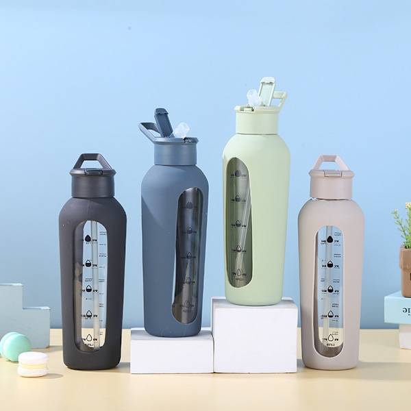 Lasinen vesipullo oljella ja kahvalla, juoma-aikamerkinnöillä 700ml