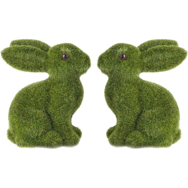 2 styrofoamfigurer av påskkaniner i mossa