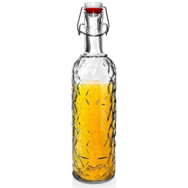 Vacker glasflaska med kork och klämma för drycker