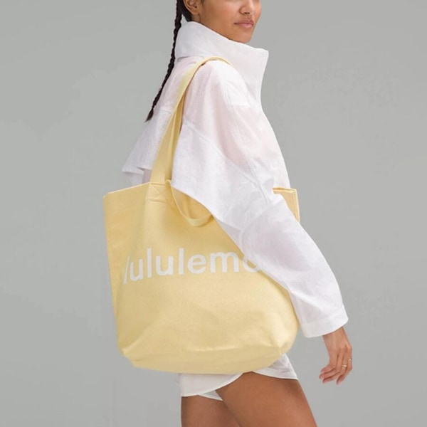 lulu Fashion Trendig Stor Kapacitet Lulu Canvas Tote Bag för Män och Kvinnor Studenter Resa Yoga Bag Fitness Sport Tote Bag Enkelsidig Axelväska Yellow