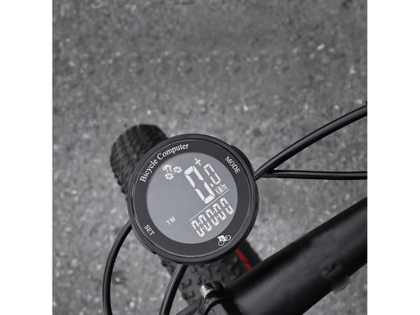 Rund trådløs cykelcomputer, sort baggrund med hvid tekstvisning