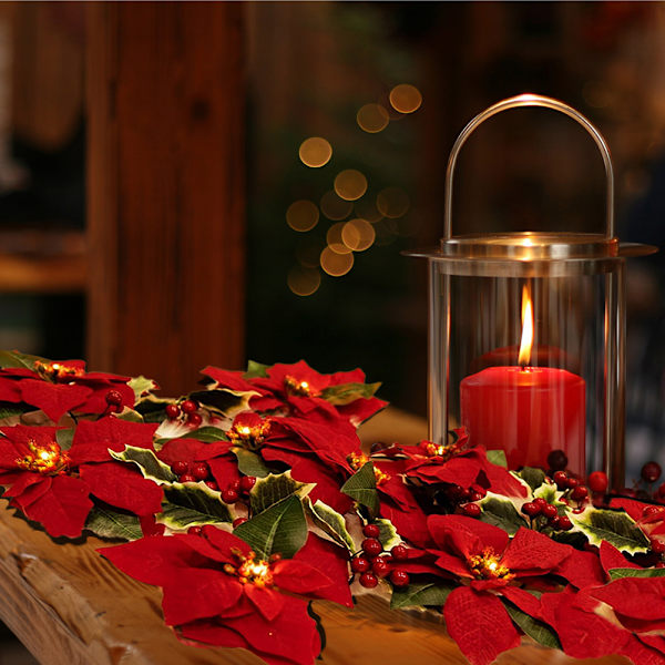 Juldekorationer med julstjärneblommor och ljusslingor